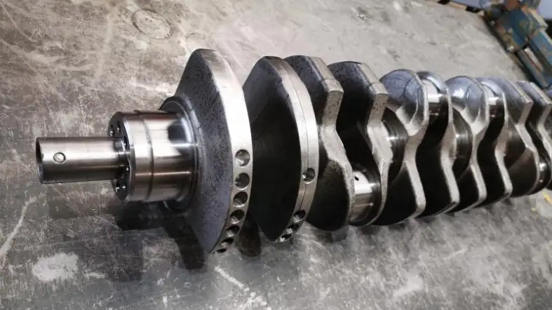 What is the function of the flywheel flange on a crankshaft