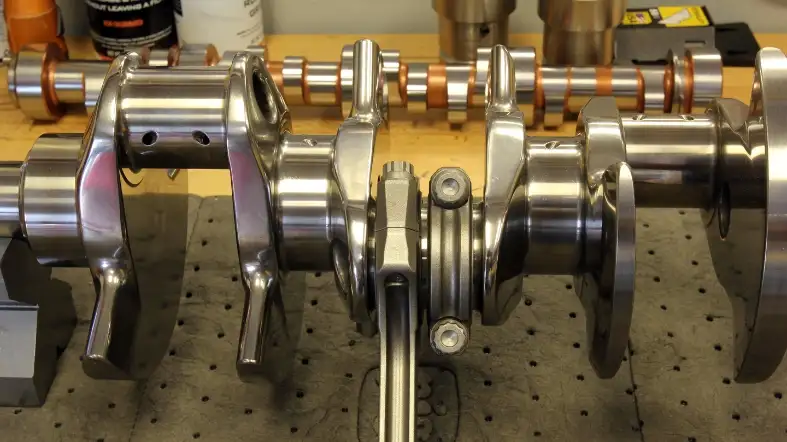 What is the purpose of the rod journal on a crankshaft